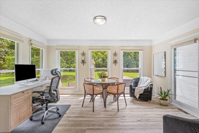1205 Holton Rd, Grove City, OH 43123 - sunroom / solarium featuring a textured ceiling, wood finished floors, baseboards, and a deck