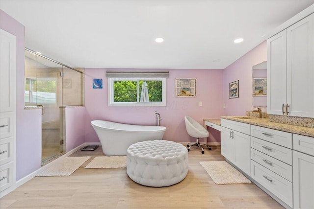 1205 Holton Rd, Grove City, OH 43123 - bathroom featuring vanity, a stall shower, a soaking tub, wood finished floors, and recessed lighting