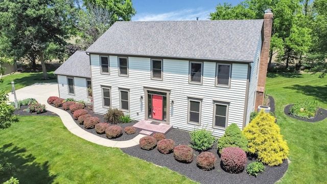 7714 Glenwood Ct NW, Canal Winchester, OH 43110 - colonial inspired home with a chimney, a front lawn, and a shingled roof