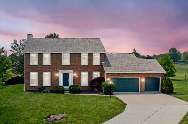 9302 Pimlico Pl, Pickerington, OH 43147 - colonial-style house with an attached garage, concrete driveway, brick siding, and a yard