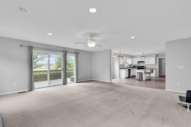 9302 Pimlico Pl, Pickerington, OH 43147 - unfurnished living room featuring light carpet, baseboards, recessed lighting, and a ceiling fan