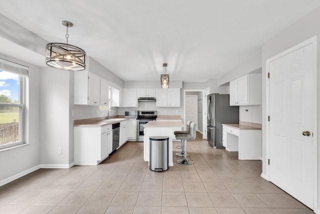 9302 Pimlico Pl, Pickerington, OH 43147 - kitchen with stainless steel appliances, a sink, light tile patterned flooring, and white cabinets