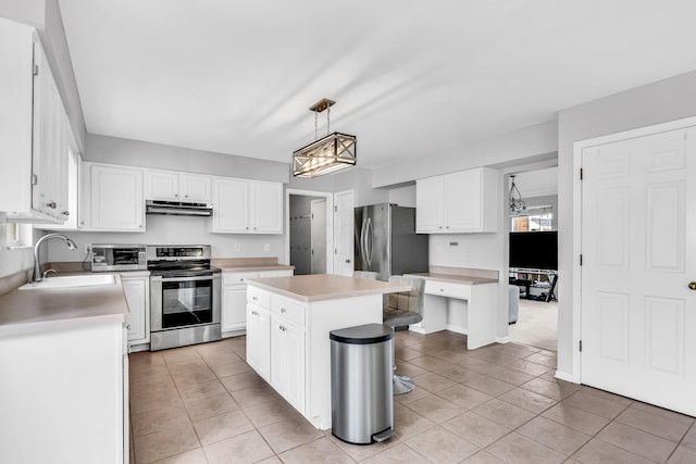 9302 Pimlico Pl, Pickerington, OH 43147 - kitchen with appliances with stainless steel finishes, a sink, light tile patterned flooring, under cabinet range hood, and light countertops