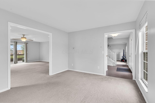9302 Pimlico Pl, Pickerington, OH 43147 - carpeted empty room with stairway, baseboards, a ceiling fan, and tile patterned flooring