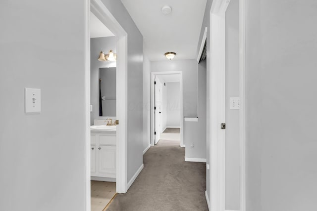 9302 Pimlico Pl, Pickerington, OH 43147 - hallway featuring a sink, baseboards, and light carpet