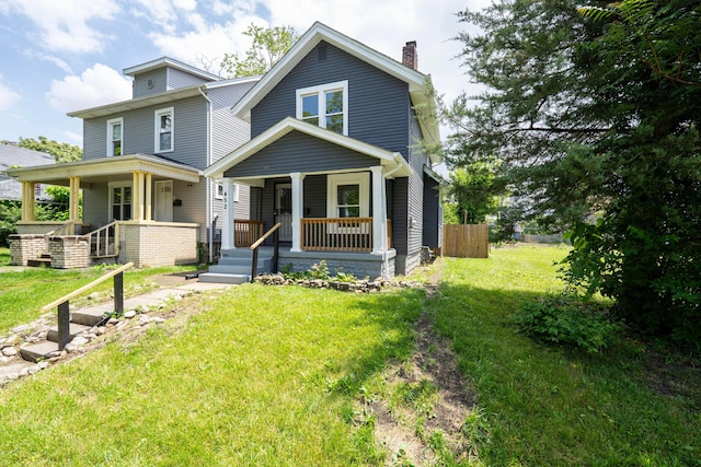 452 N Ohio Ave, Columbus, OH 43203 - traditional style home featuring a chimney, covered porch, and a front yard