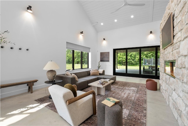3226 Bean Oller Rd, Delaware, OH 43015 - living room featuring high vaulted ceiling, ceiling fan, a stone fireplace, concrete floors, and wood ceiling