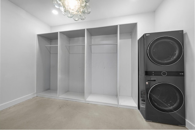 3226 Bean Oller Rd, Delaware, OH 43015 - laundry area with stacked washer / drying machine, a chandelier, and baseboards