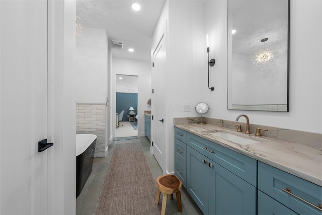 3226 Bean Oller Rd, Delaware, OH 43015 - bathroom with vanity, a freestanding bath, and recessed lighting