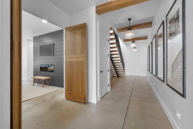 3226 Bean Oller Rd, Delaware, OH 43015 - hallway featuring concrete flooring, baseboards, and stairway