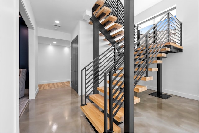 3226 Bean Oller Rd, Delaware, OH 43015 - stairway featuring concrete flooring, baseboards, and recessed lighting