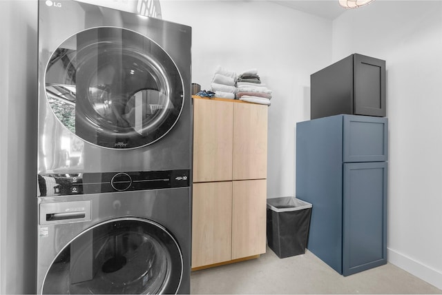 3226 Bean Oller Rd, Delaware, OH 43015 - laundry room with stacked washer / drying machine, cabinet space, and baseboards