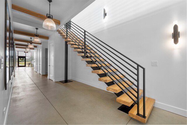 3226 Bean Oller Rd, Delaware, OH 43015 - stairs with baseboards, concrete flooring, and beamed ceiling