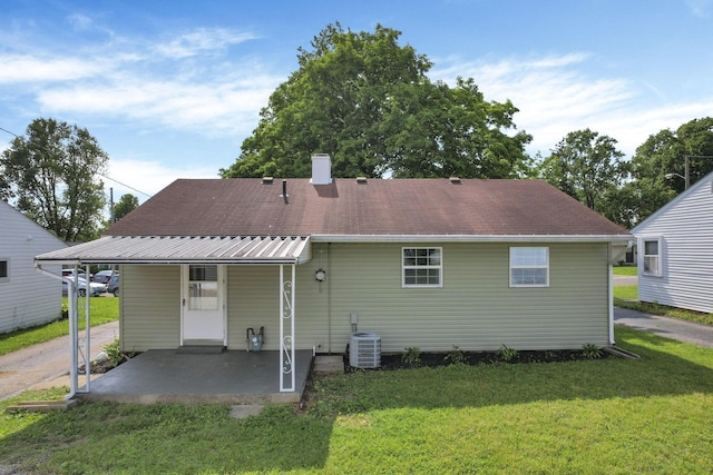 46 S 24th St, Newark, OH 43055 - back of property featuring a yard, central AC unit, a patio, and a chimney