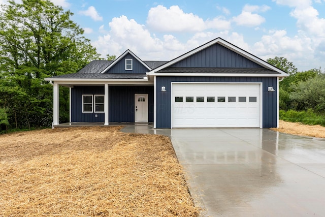 13567 Magers Rd, Howard, OH 43028 - view of front of property featuring concrete driveway, a porch, an attached garage, and a shingled roof