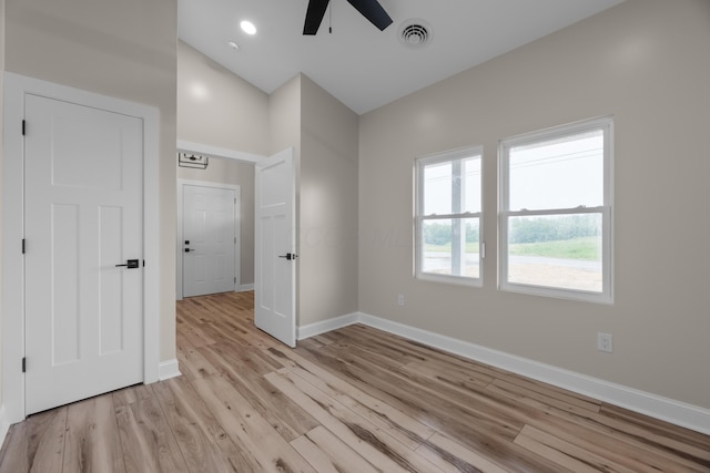 13567 Magers Rd, Howard, OH 43028 - unfurnished bedroom with baseboards, light wood-style flooring, a ceiling fan, and lofted ceiling