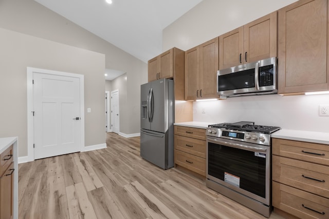 13567 Magers Rd, Howard, OH 43028 - kitchen featuring appliances with stainless steel finishes, lofted ceiling, light countertops, and light wood finished floors