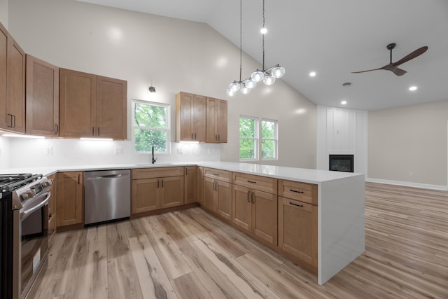 13567 Magers Rd, Howard, OH 43028 - kitchen featuring appliances with stainless steel finishes, high vaulted ceiling, a peninsula, a sink, and ceiling fan