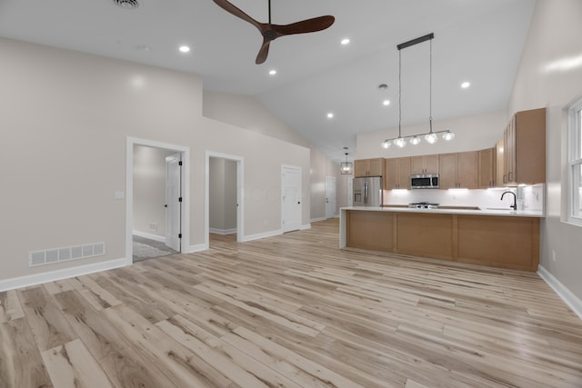 13567 Magers Rd, Howard, OH 43028 - kitchen featuring stainless steel appliances, open floor plan, ceiling fan, light countertops, and high vaulted ceiling