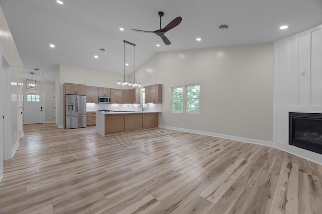 13567 Magers Rd, Howard, OH 43028 - kitchen featuring appliances with stainless steel finishes, open floor plan, plenty of natural light, a ceiling fan, and high vaulted ceiling