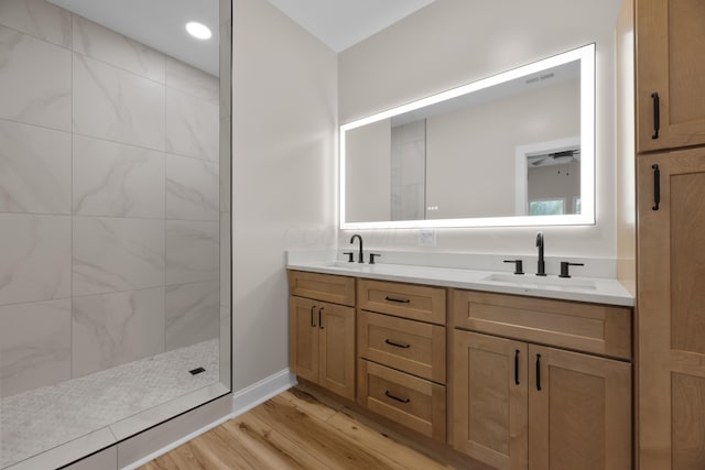 13567 Magers Rd, Howard, OH 43028 - bathroom featuring double vanity, wood finished floors, a walk in shower, and baseboards