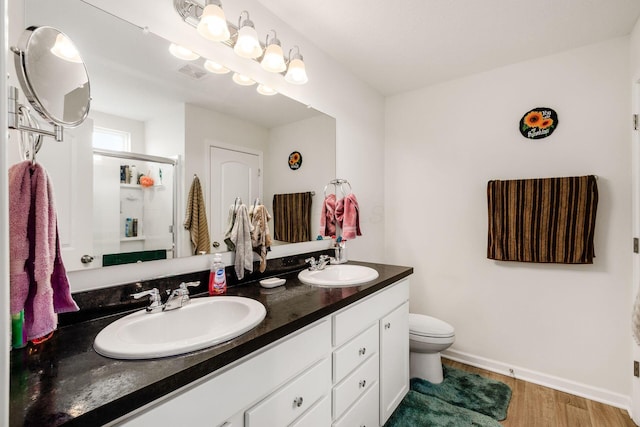 99 Hutchison St, South Bloomfield, OH 43103 - full bathroom featuring double vanity, wood finished floors, and a shower stall