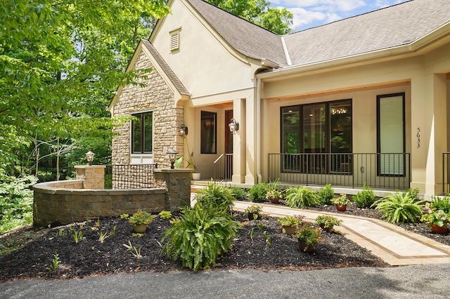 5633 Travis Pointe Ct, Westerville, OH 43082 - view of front of property featuring covered porch, stucco siding, roof with shingles, and stone siding