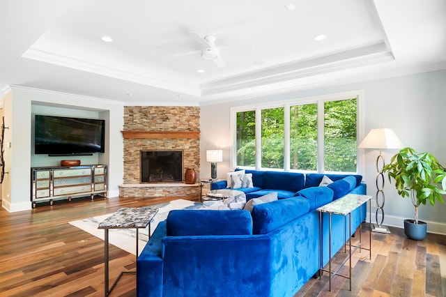 5633 Travis Pointe Ct, Westerville, OH 43082 - living area featuring a tray ceiling, ceiling fan, wood finished floors, a fireplace, and recessed lighting