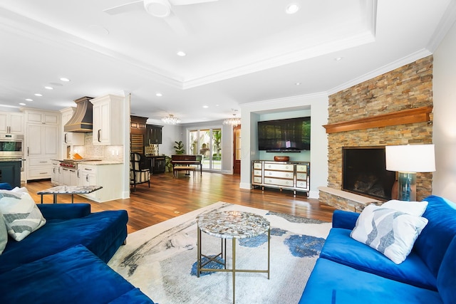 5633 Travis Pointe Ct, Westerville, OH 43082 - living room featuring a raised ceiling, wood finished floors, a ceiling fan, crown molding, and recessed lighting