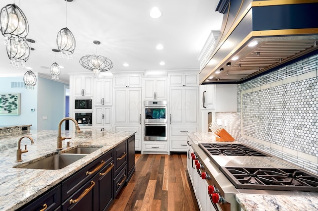 5633 Travis Pointe Ct, Westerville, OH 43082 - kitchen with a sink, wall chimney range hood, appliances with stainless steel finishes, white cabinetry, and dark wood-type flooring