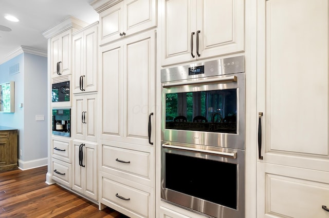 5633 Travis Pointe Ct, Westerville, OH 43082 - kitchen with double oven, baseboards, crown molding, dark wood-style floors, and white cabinetry