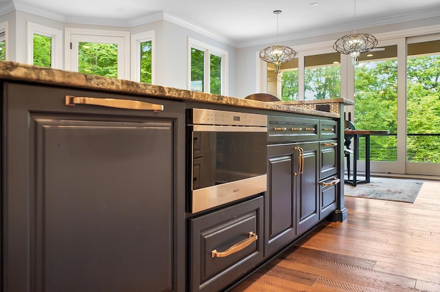 5633 Travis Pointe Ct, Westerville, OH 43082 - kitchen with dark wood-style floors, a chandelier, ornamental molding, wall oven, and pendant lighting