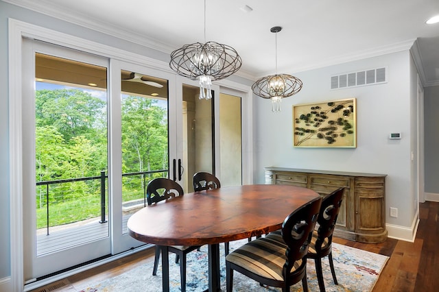 5633 Travis Pointe Ct, Westerville, OH 43082 - dining room featuring plenty of natural light, dark wood-style flooring, crown molding, and a chandelier
