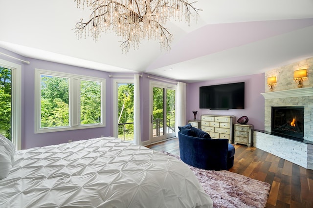 5633 Travis Pointe Ct, Westerville, OH 43082 - bedroom featuring multiple windows, lofted ceiling, wood finished floors, access to outside, and a stone fireplace