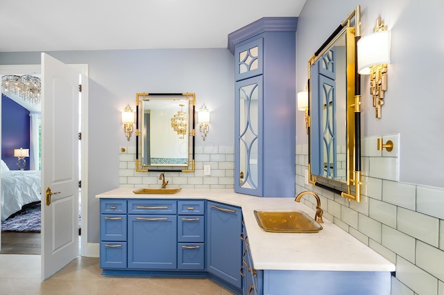 5633 Travis Pointe Ct, Westerville, OH 43082 - ensuite bathroom featuring double vanity, decorative backsplash, and tile patterned floors