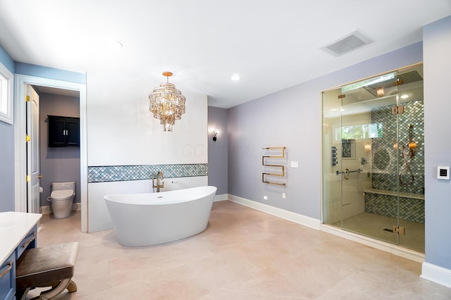 5633 Travis Pointe Ct, Westerville, OH 43082 - bathroom with vanity, a shower stall, a freestanding bath, toilet, and a chandelier
