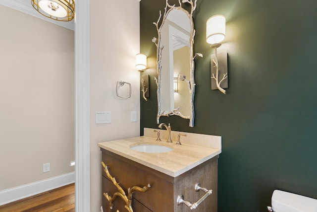 5633 Travis Pointe Ct, Westerville, OH 43082 - bathroom with toilet, vanity, wood finished floors, baseboards, and ornamental molding