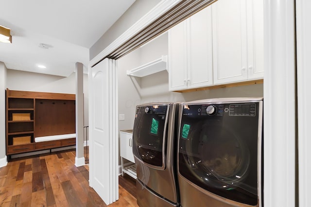 5633 Travis Pointe Ct, Westerville, OH 43082 - laundry room featuring cabinet space, washing machine and dryer, and wood finished floors