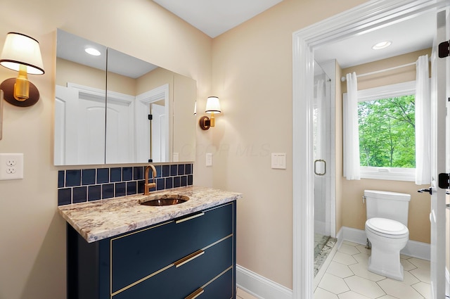 5633 Travis Pointe Ct, Westerville, OH 43082 - bathroom featuring vanity, a stall shower, baseboards, and toilet