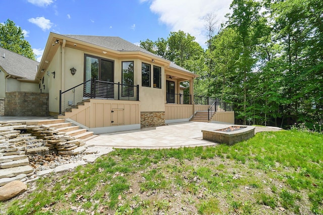 5633 Travis Pointe Ct, Westerville, OH 43082 - rear view of property featuring stairway, an outdoor fire pit, a patio area, and stucco siding
