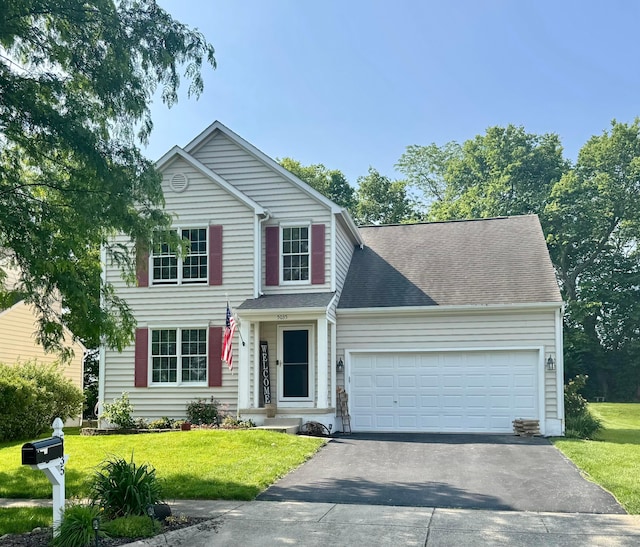 5035 Dietrich Ave, Orient, OH 43146 - traditional-style home with asphalt driveway, a garage, a front yard, and roof with shingles