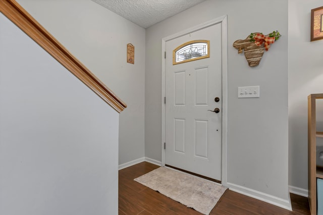 5035 Dietrich Ave, Orient, OH 43146 - foyer entrance with dark wood finished floors, baseboards, and a textured ceiling