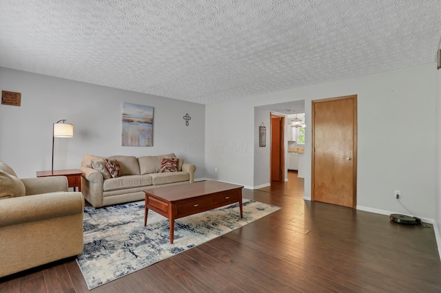 5035 Dietrich Ave, Orient, OH 43146 - living room featuring a chandelier, a textured ceiling, dark wood-style floors, and baseboards
