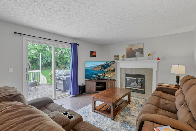 5035 Dietrich Ave, Orient, OH 43146 - living area featuring a fireplace, a textured ceiling, and light wood-style floors