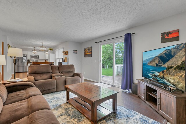 5035 Dietrich Ave, Orient, OH 43146 - living area featuring wood finished floors, a chandelier, and a textured ceiling