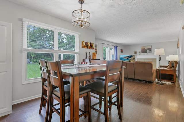 5035 Dietrich Ave, Orient, OH 43146 - dining area featuring a textured ceiling, a chandelier, dark wood-style floors, and baseboards