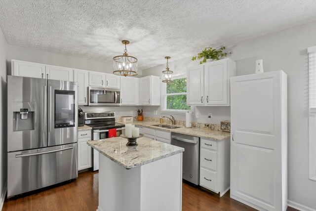 5035 Dietrich Ave, Orient, OH 43146 - kitchen featuring appliances with stainless steel finishes, white cabinets, dark wood-style flooring, and a textured ceiling