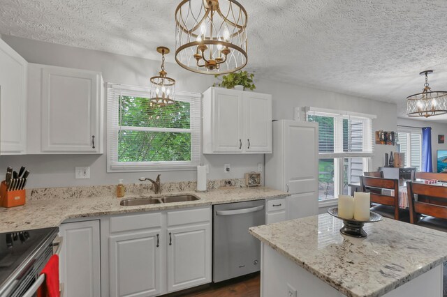 5035 Dietrich Ave, Orient, OH 43146 - kitchen featuring appliances with stainless steel finishes, a chandelier, a sink, a textured ceiling, and white cabinetry
