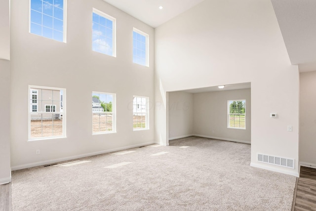 7014 Aster Way, Plain City, OH 43064 - carpeted empty room featuring a towering ceiling and baseboards