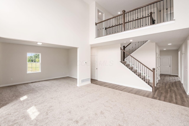 7014 Aster Way, Plain City, OH 43064 - unfurnished living room with carpet, a high ceiling, stairway, baseboards, and recessed lighting